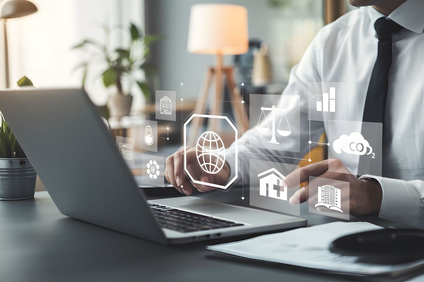 Consultant using a laptop with digital icons for security, compliance, cloud and data